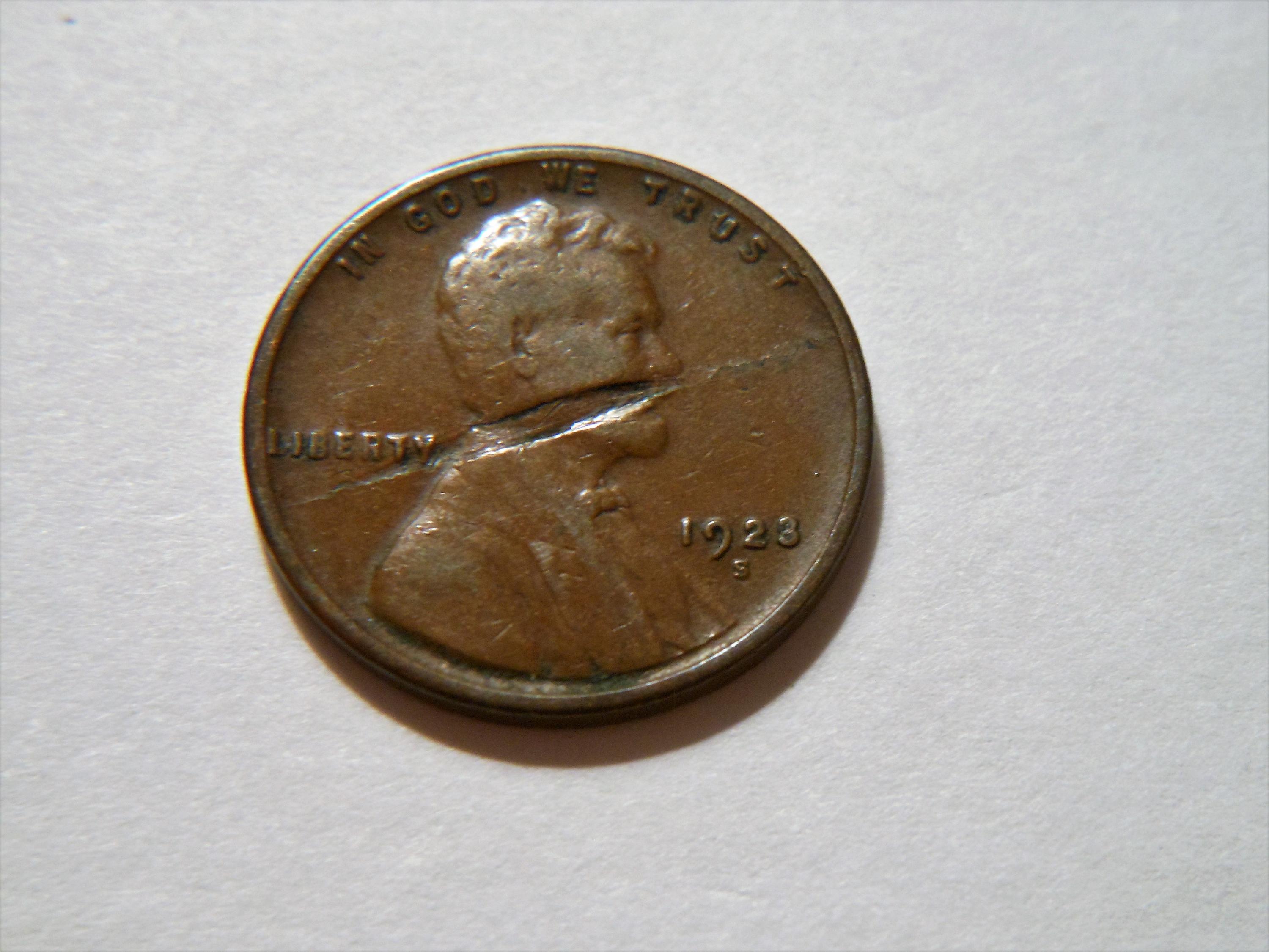 1923 wheat penny lamination error showing a surface crack and peeling metal flaw on the coin face